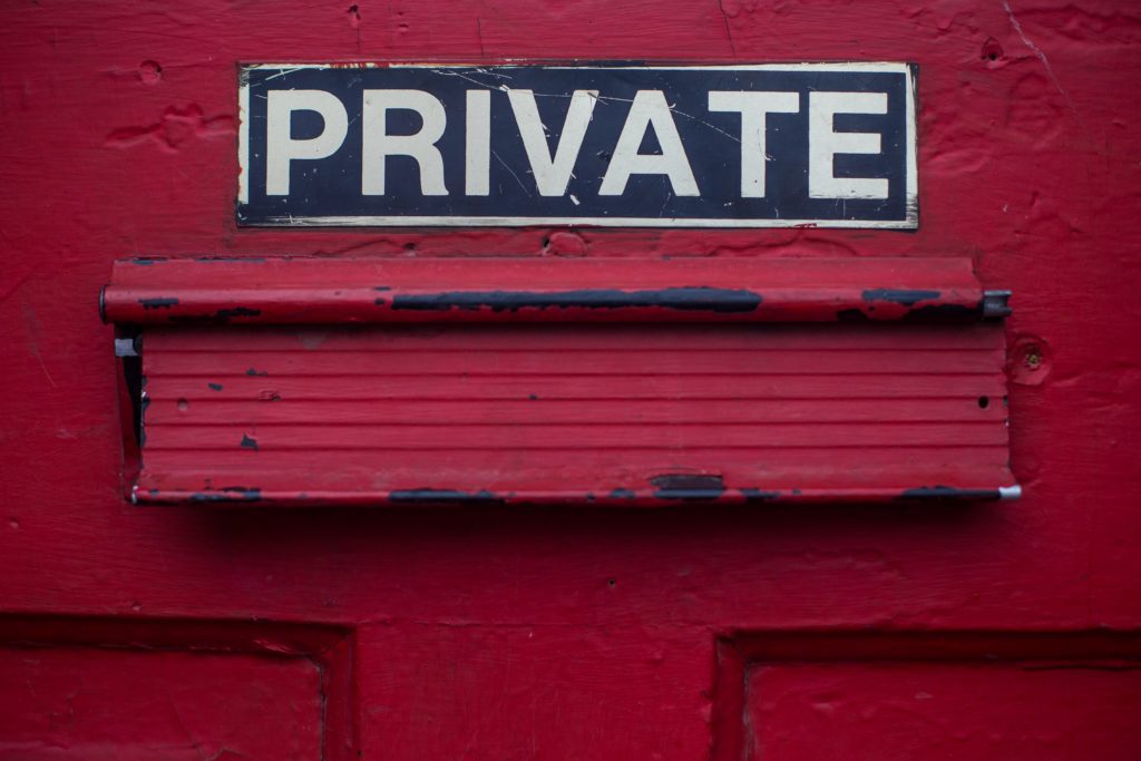 red wall with a sign with the word private