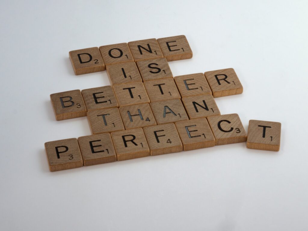 Wooden scrabble letters read 'done is better than perfect' 